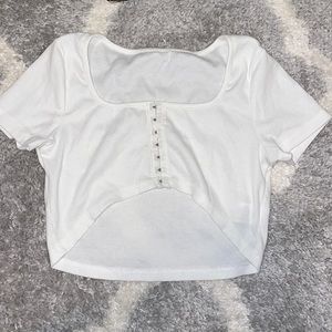 White cropped T-shirt in the front long in the back. Never worn.